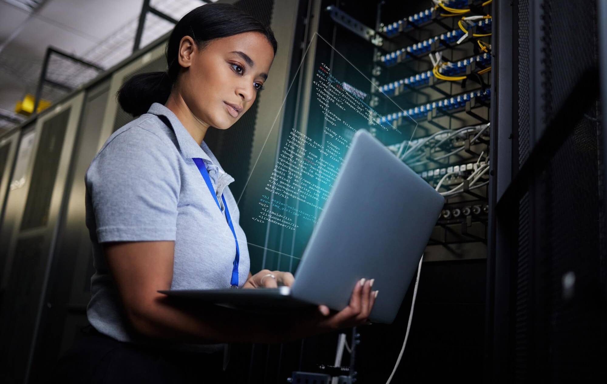 Woman working on cybersecurity systems in data centre during Pitman Training CompTIA Security+ diploma course.